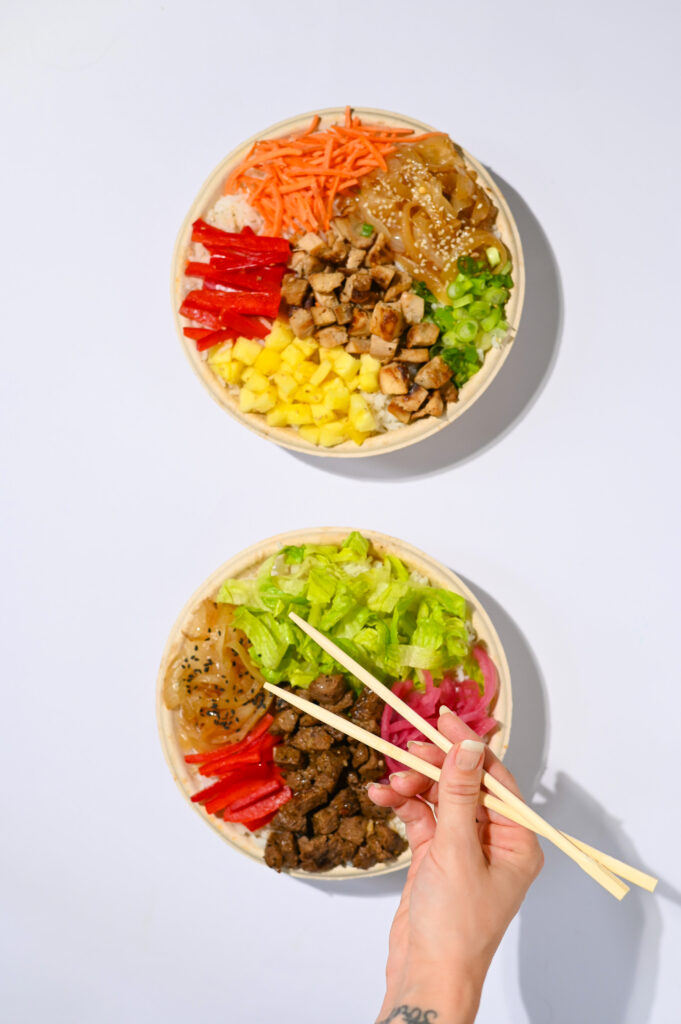 Asian fusion colorful meal with a hand using chopsticks eating food in the united states 